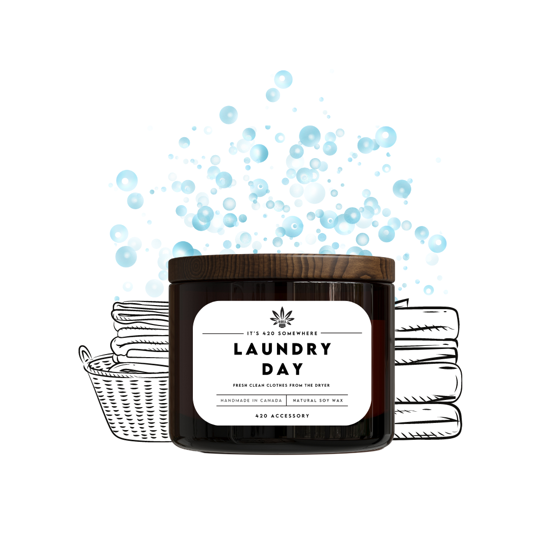 Candle labeled 'Laundry Day' with soap bubbles and a basket of laundry on a white background